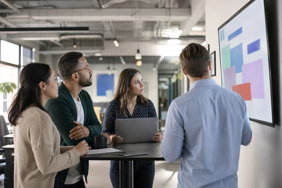 Sales and marketing colleagues reacting to a competitor change on a shared screen