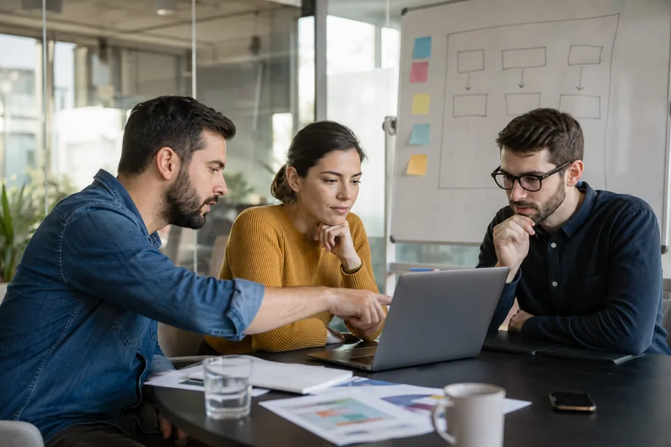 Small software team discussing a competitor price change in a meeting room